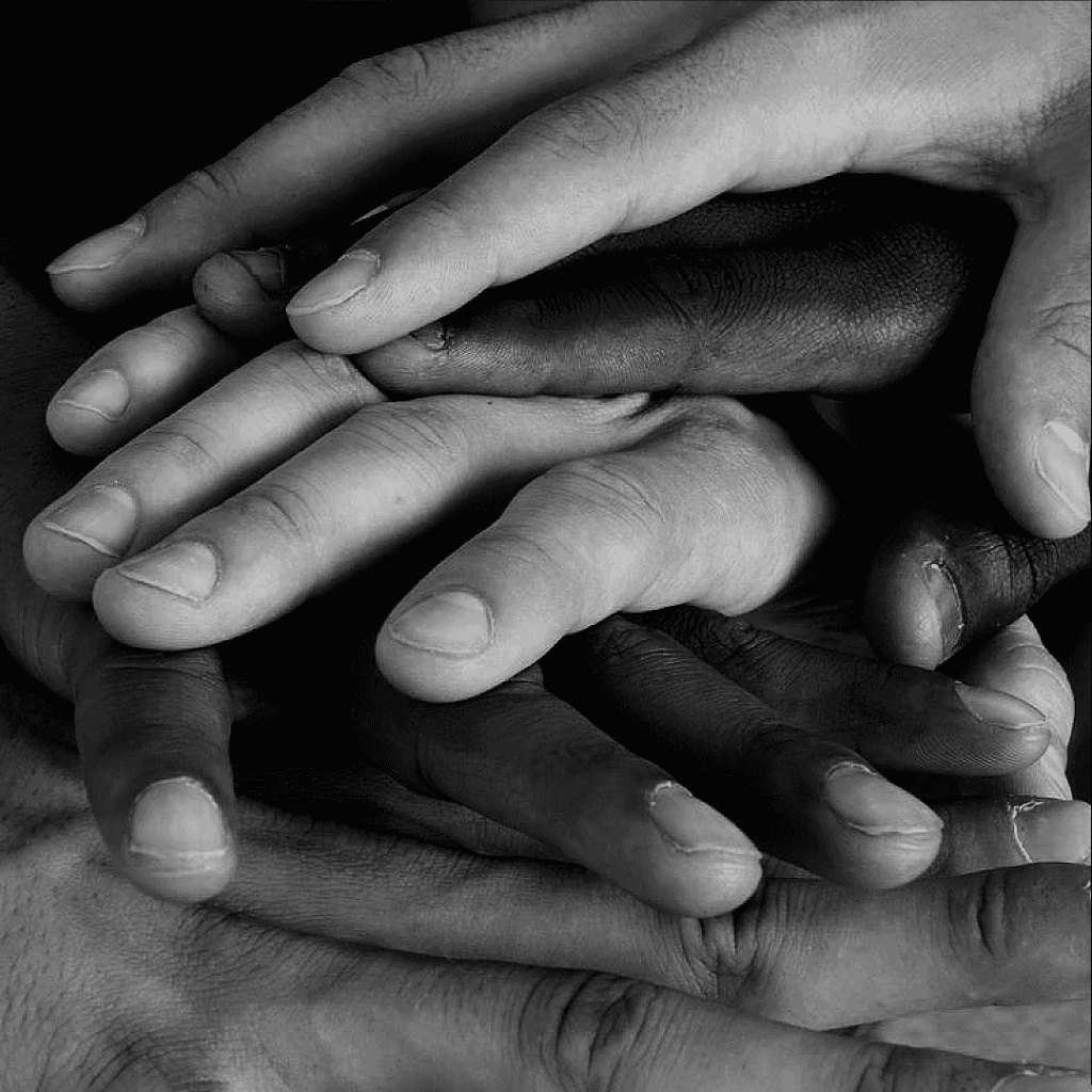 Diverse hands joined together representing collaboration and trust