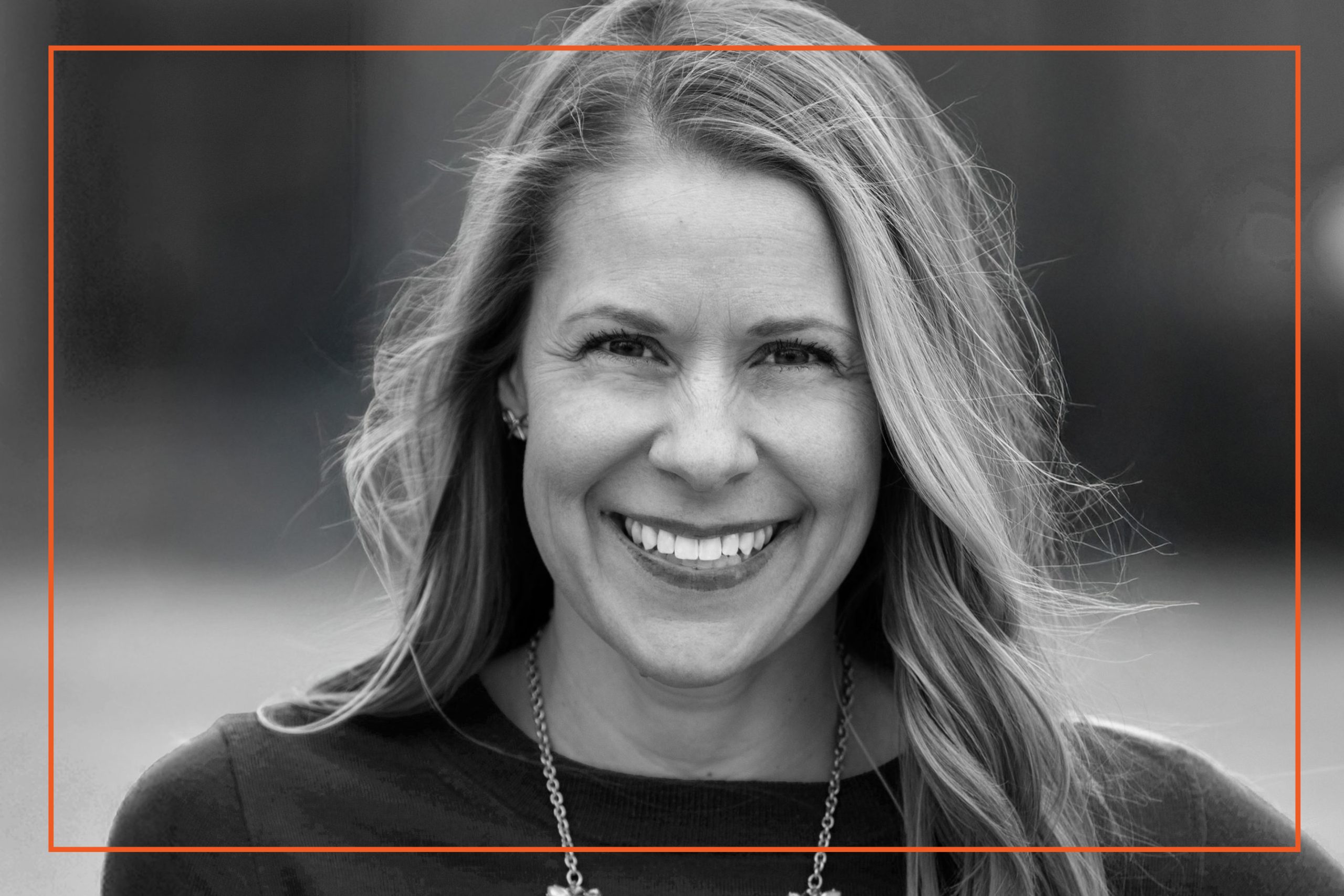 Portrait of a smiling woman representing Co-hesion, experts in cultural change, leadership, and execution.