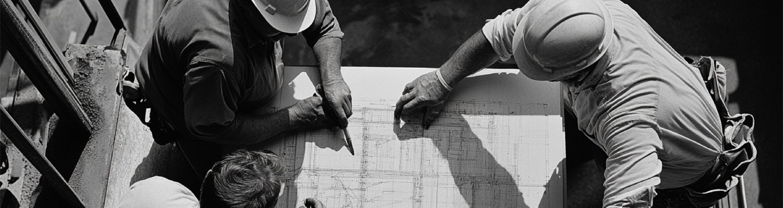 B2B field service workers collaborating over a blueprint, symbolizing team alignment and execution